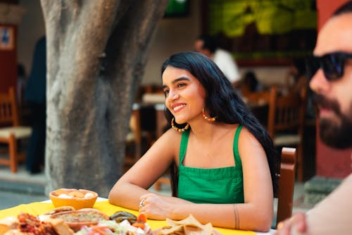 Free Woman in Green Tank Top Eating Mexican Food Stock Photo