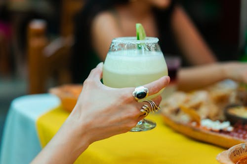 Free Person Holding a Cocktail Drink Stock Photo