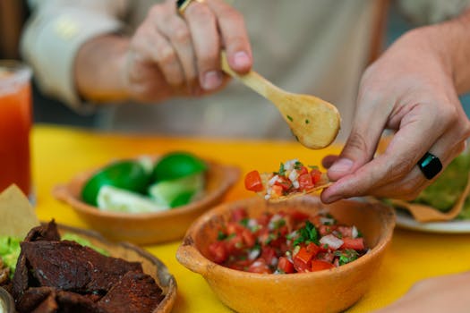 Vibrant Mexican meal with salsa, meat, and lime wedges, evoking traditional flavors.