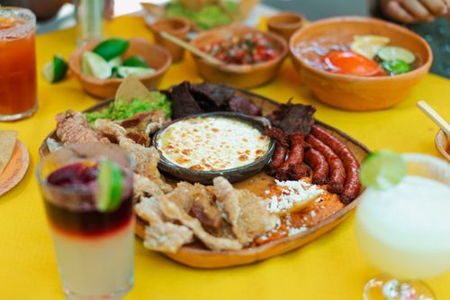 Free A vibrant spread of traditional Mexican food on a colorful table, perfect for a festive meal. Stock Photo
