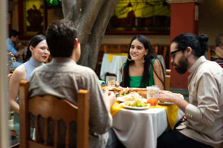 Group Of Friends Eating At Mexican Restaurant