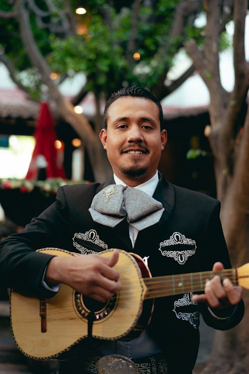 Free Man in Black Charro Playing Guitar Stock Photo