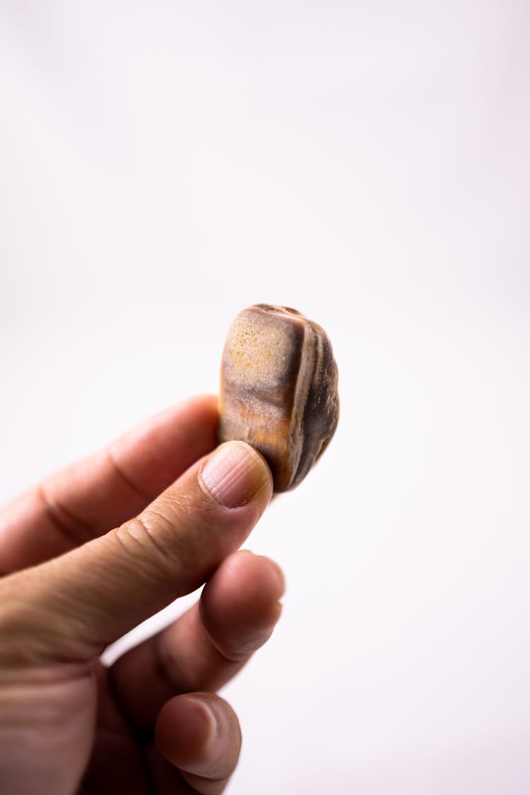 Person Holding Brown Heart Shaped Stone