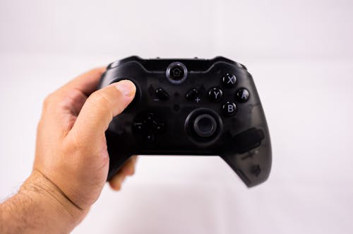 Free Crop gamer playing videogame on white background Stock Photo