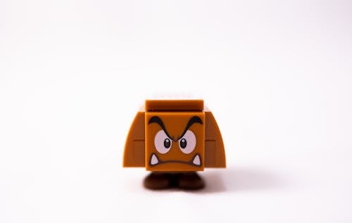 Small brow toy of evil mushroom made of plastic details against white background