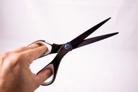 Scissors in hand of crop person