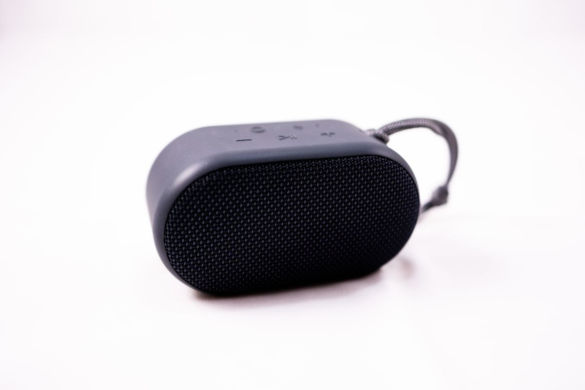 Compact portable speaker with a woven grille on a pale studio backdrop — photo by Caleb Oquendo on Pexels