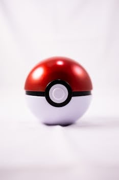 Detailed image of a classic red and white Poké Ball on a clean white background, perfect for gaming and animation themes.