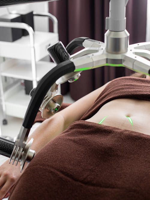 Unrecognizable woman getting weight loss procedure