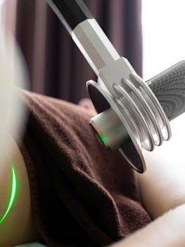 Close-up of laser machine used in a modern medical therapy session indoors.