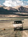 People driving in van in mountainous desert