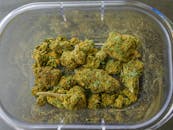 Photo of Cannabis Flowers on Glass Container