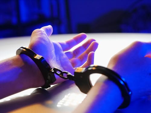 Free A Person with Black Handcuffs Stock Photo