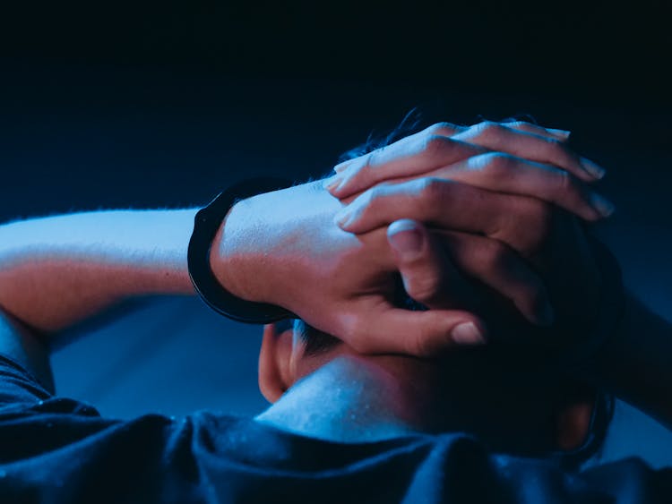 Close-up Shot Of An Arrested Person With Handcuffs