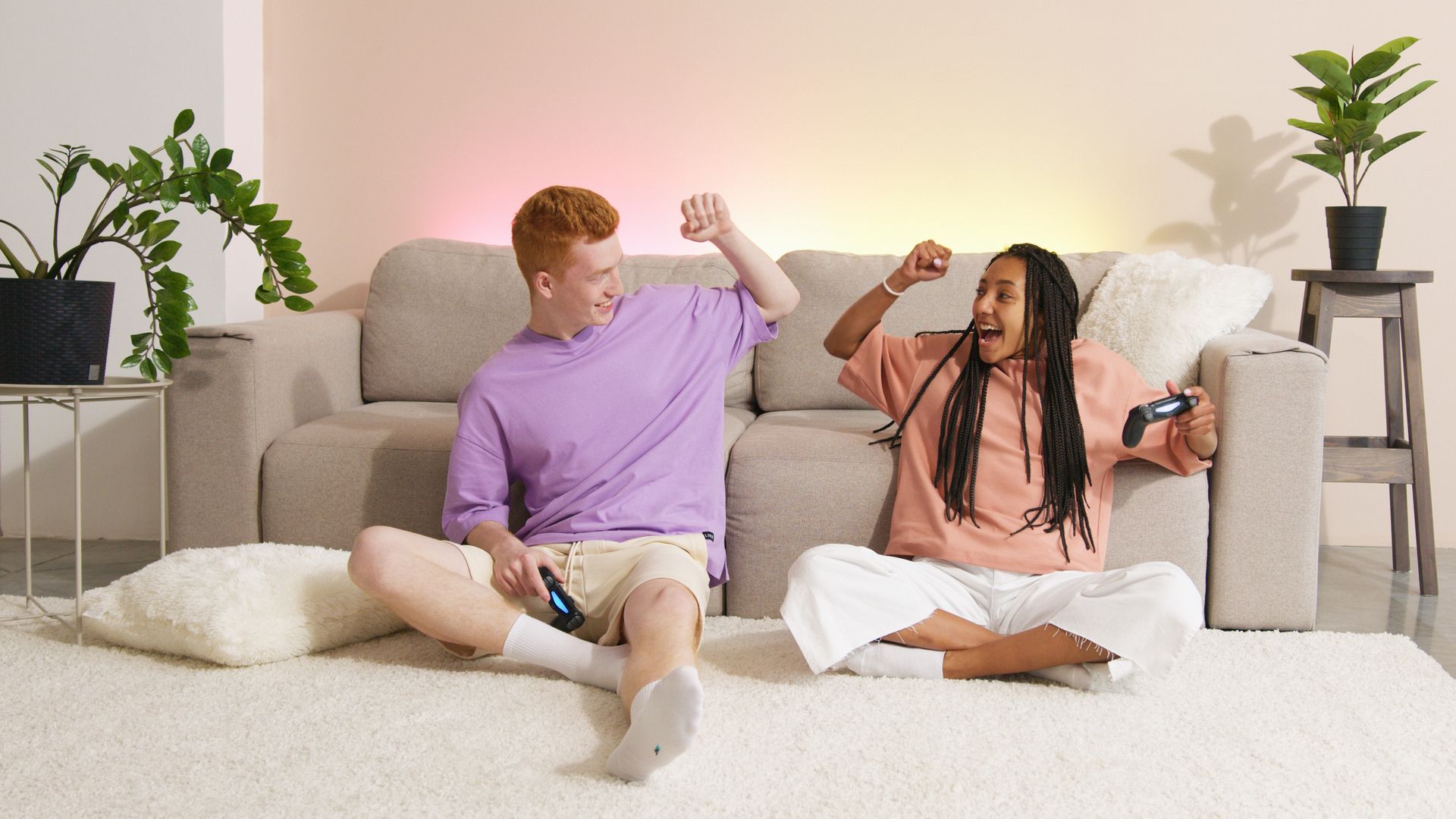 A Man and Woman Sitting on the Floor while Playing Video Games