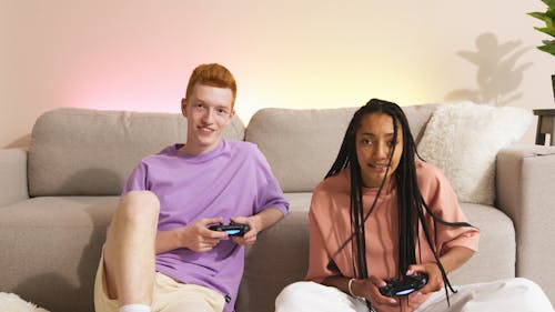 Teenagers Playing Console Game with Wireless Controllers