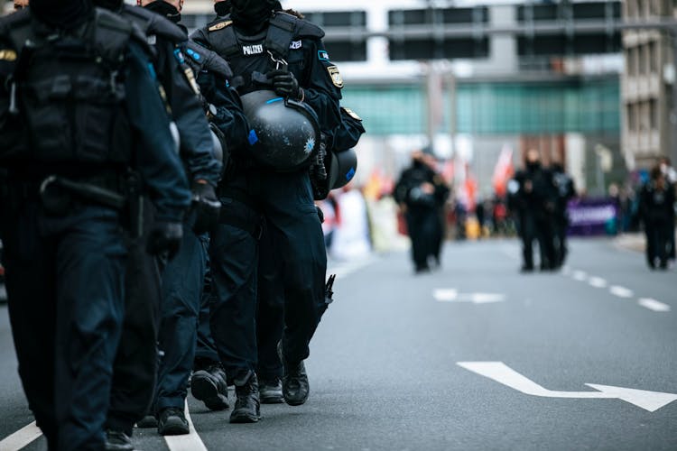 Shallow Focus Of Police Officers Marching Together