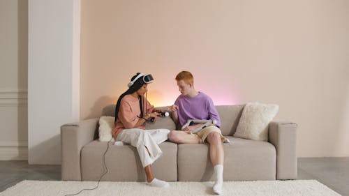 Man and Woman Sitting on Brown Couch