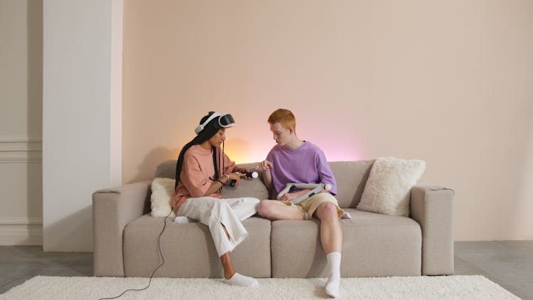 Man And Woman Sitting On Brown Couch