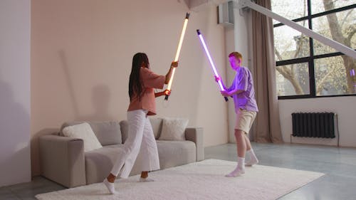 A Man and a Woman Playing with Led Lights
