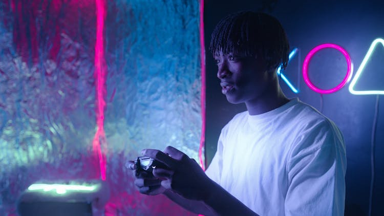 Man In White T-shirt Holding A Game Controller