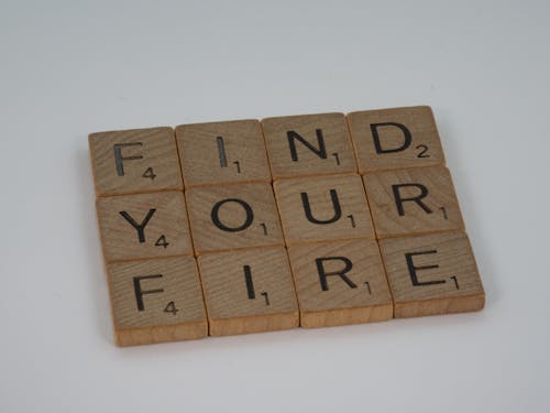 Brown Wooden Scrabble Tiles on White Table