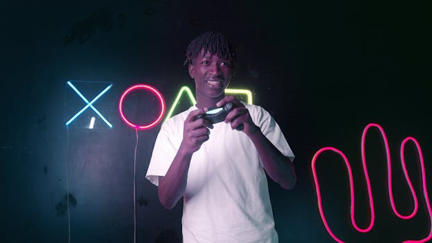 Young man enjoying gaming with vibrant neon lights in the background.