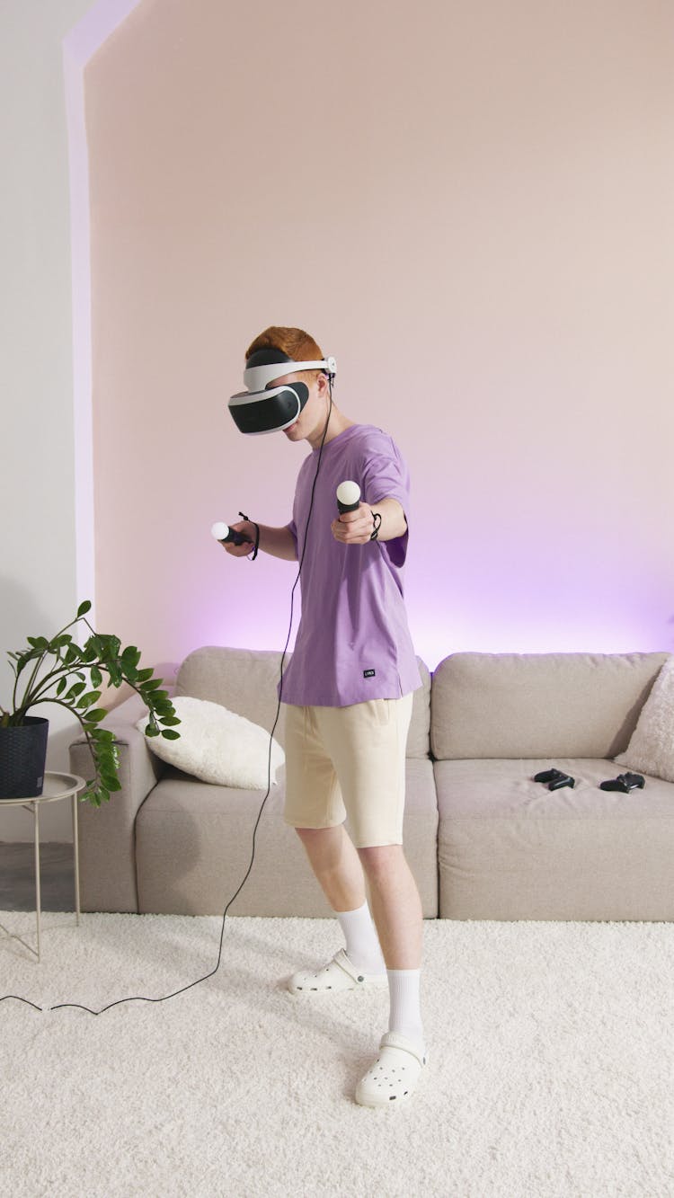 Person In Purple Shirt Playing PlayStation Vr