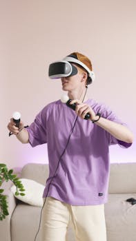 A young man in a purple shirt playing with VR controllers in a modern living room.