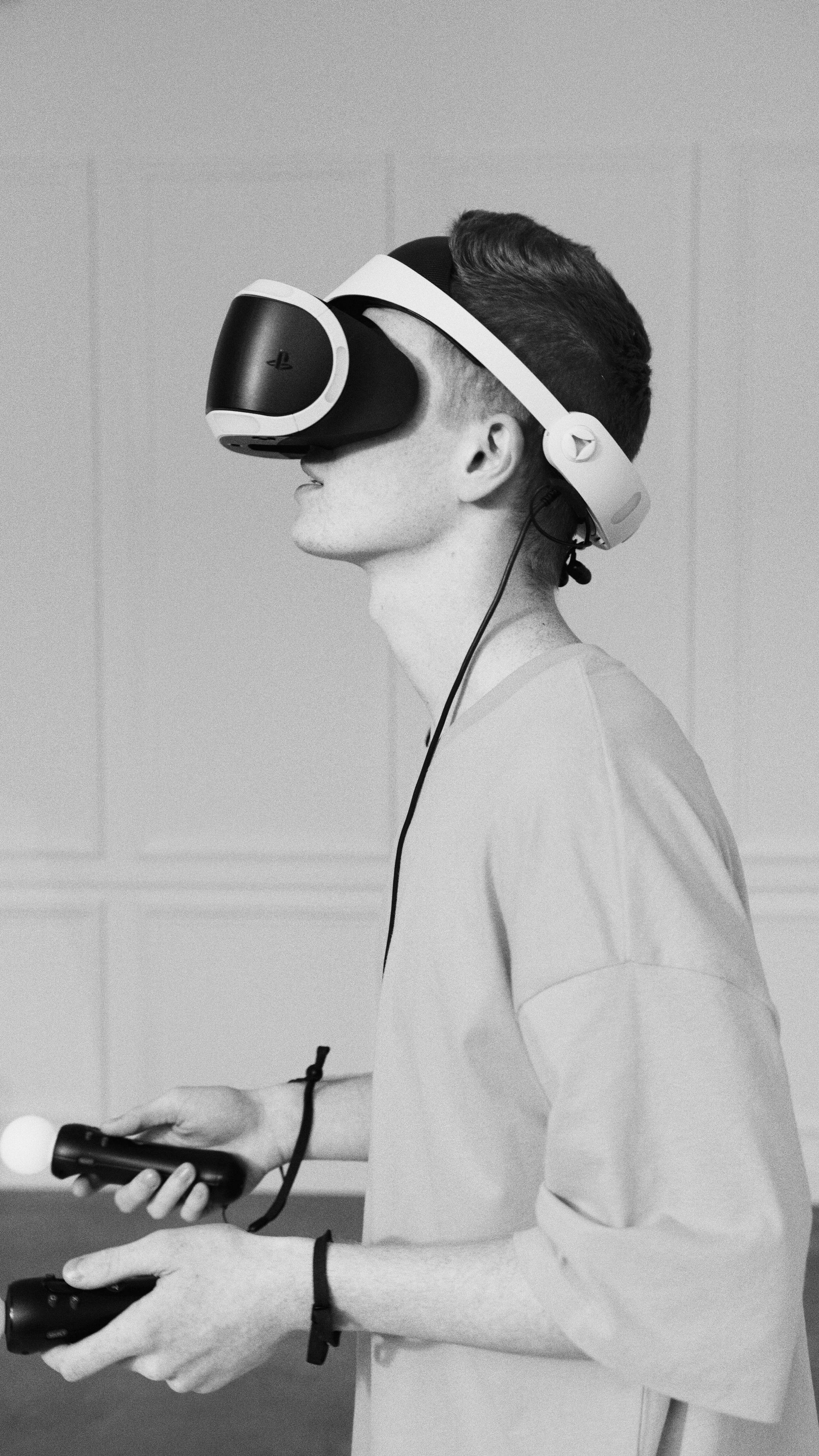 grayscale photo of person playing playstation vr