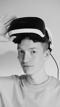 Black and white portrait of a man holding a VR headset. Stylish and modern.
