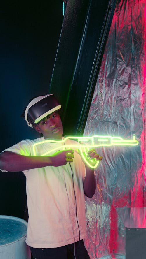 A Man Posing with a Neon Gun