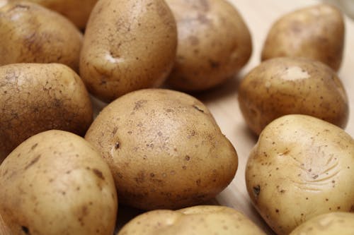 Free Close-Up Shot of Potatoes on Wooden Surface Stock Photo