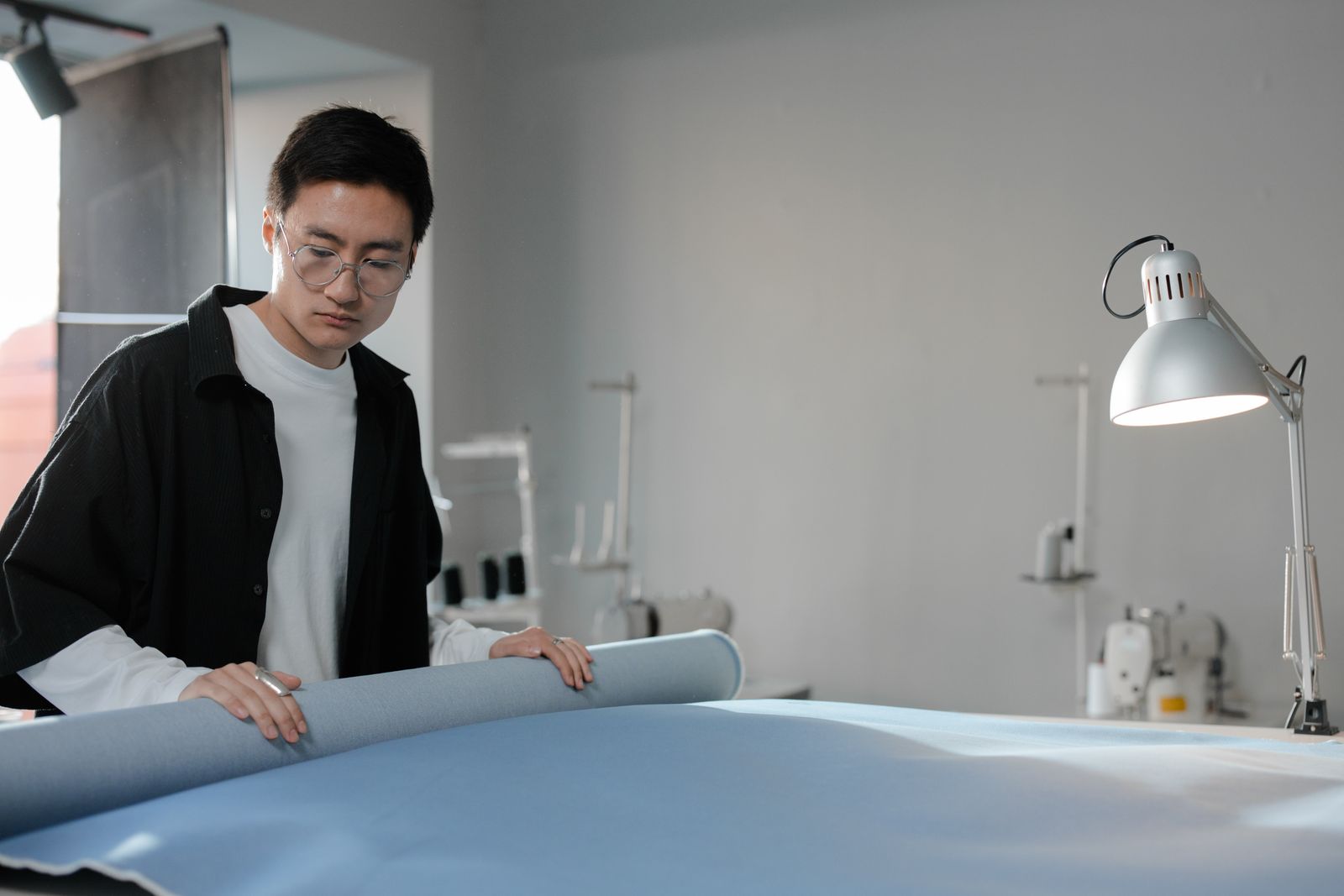 A designer examining material in a studio — photo by Ron Lach on Pexels