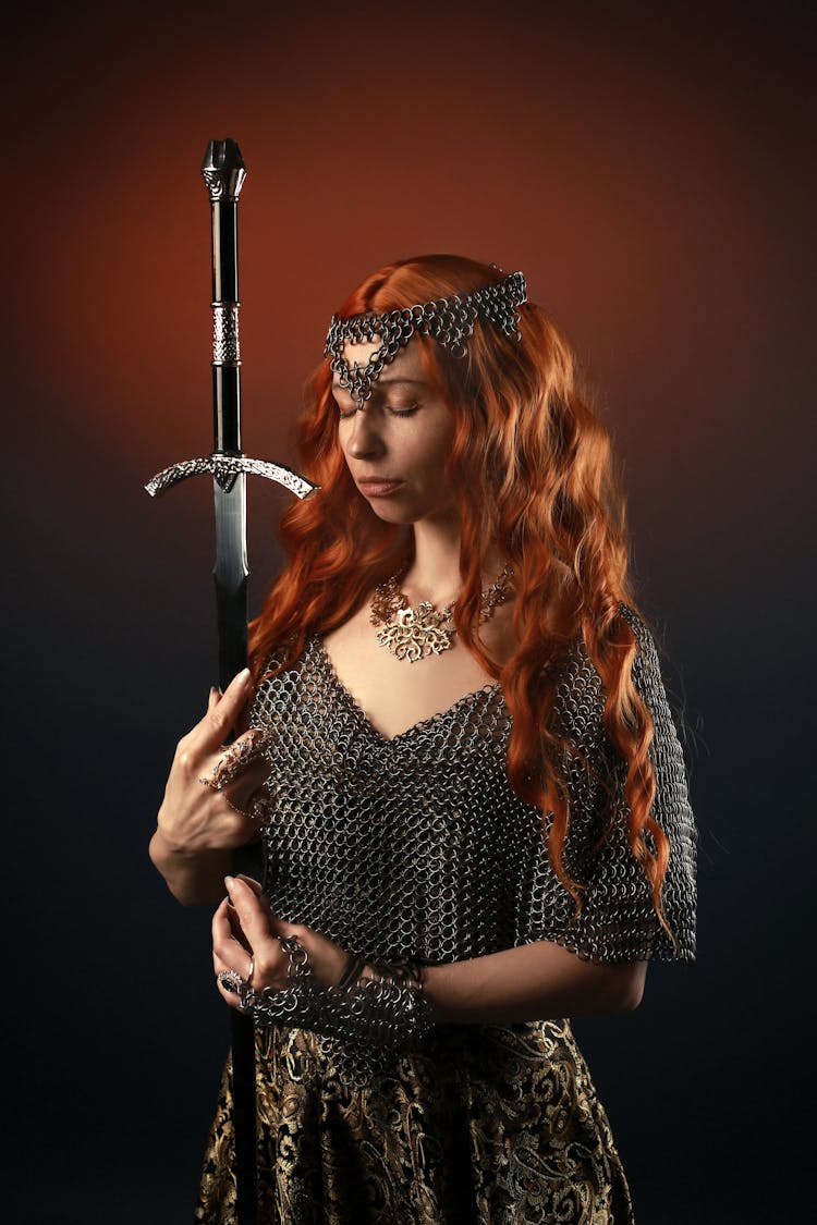Young Woman In Chainmail Armor With Sword