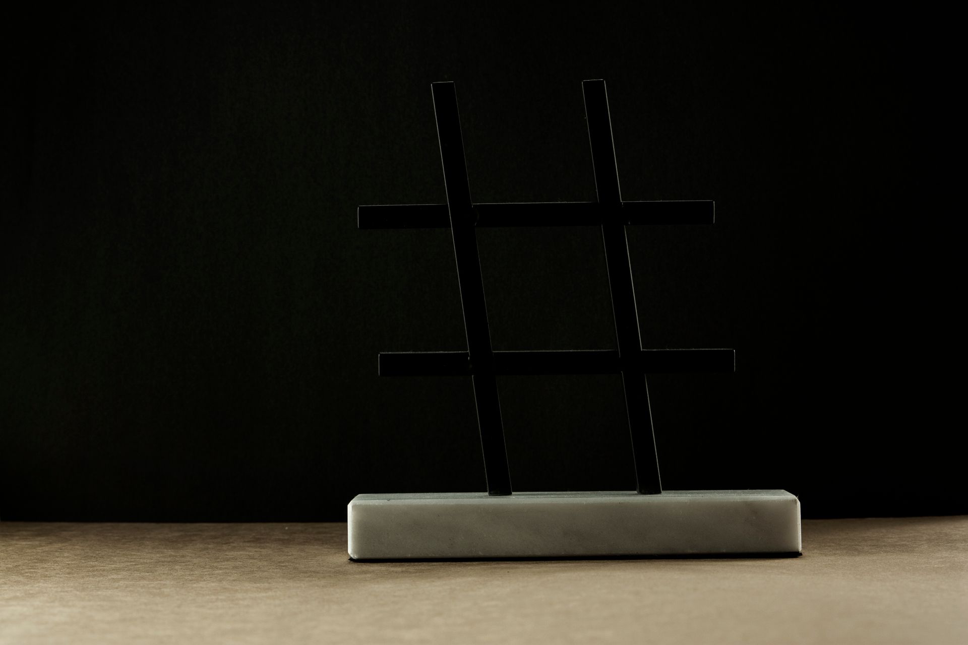 A Hashtag Statuette against a Dark Background