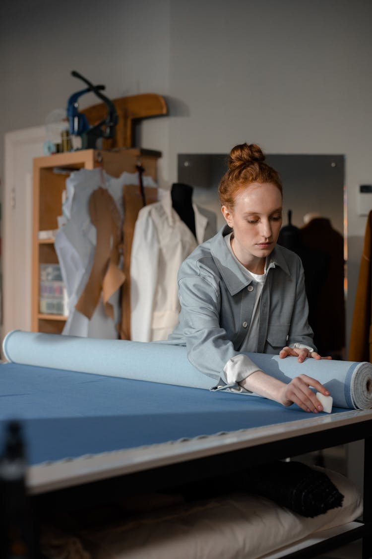 Woman Marking A Fabric With A Tailor's Chalk