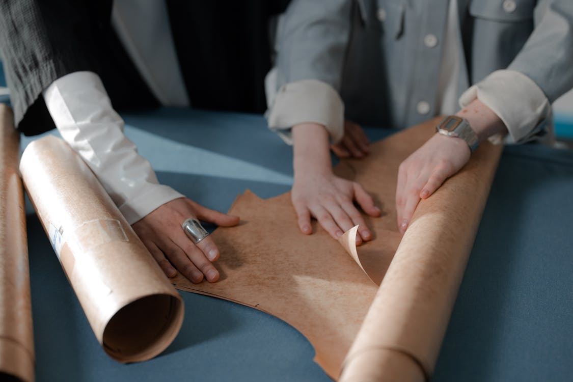 Two People Making Paper Pattern · Free Stock Photo