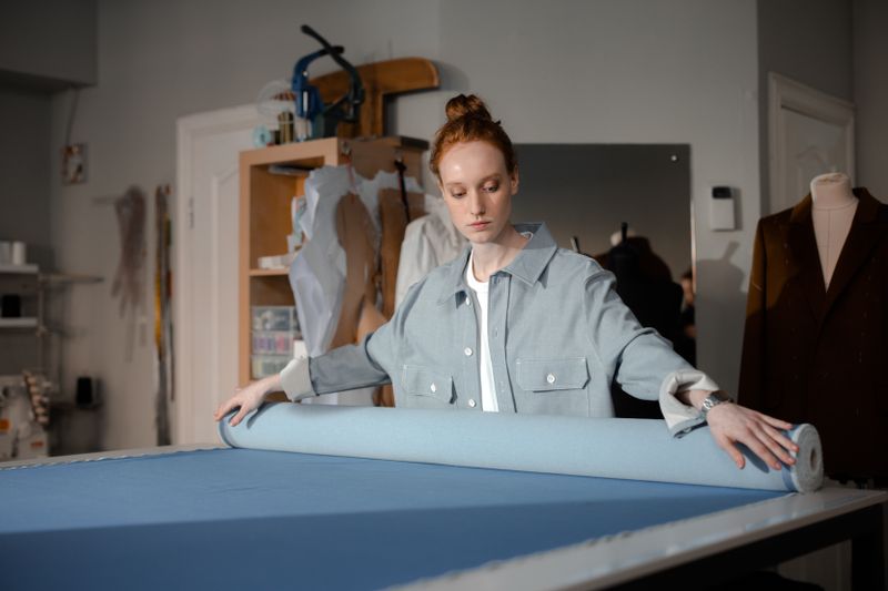 Fashion designer working with fabric in a tailoring atelier