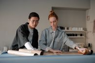 Man and Woman Making A Paper Pattern