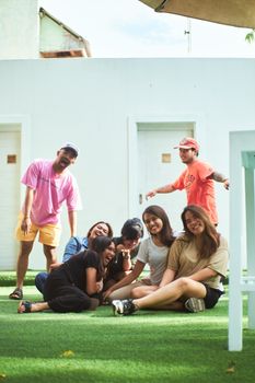 A cheerful group of friends enjoying a sunny day outdoors, smiling and laughing together.