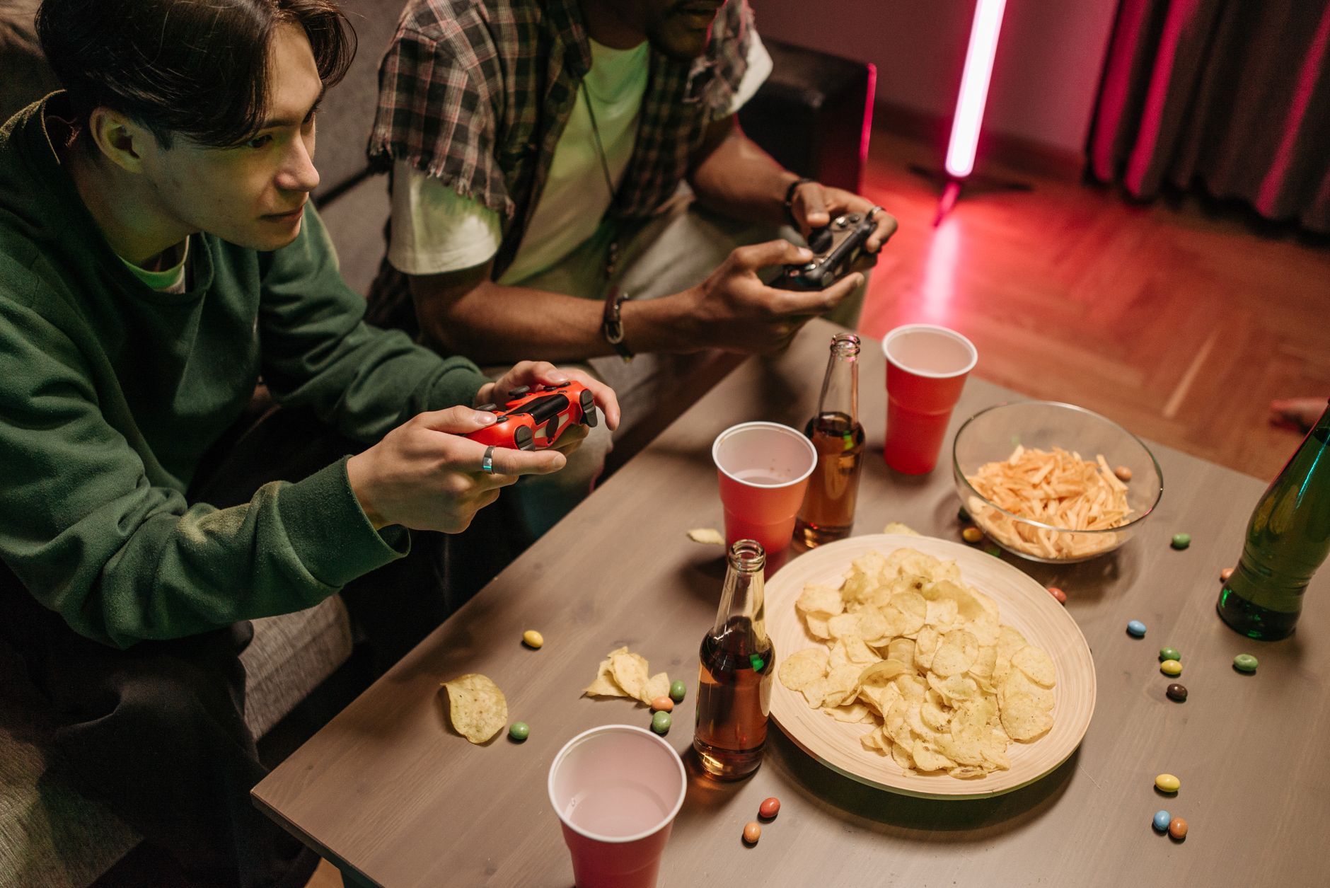 Group enjoying colorful cocktails with neon green Scooby Snack shot on table