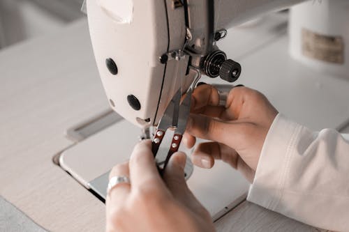A Person Cutting Thread on Sewing Machine