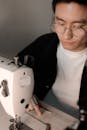 Man Sitting Beside a Sewing Machine