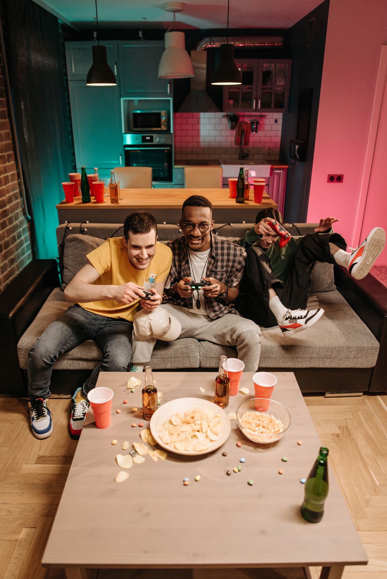 Friends sitting on a couch playing a video game together
