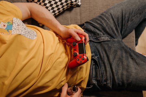 A Person Holding Red Game Controller