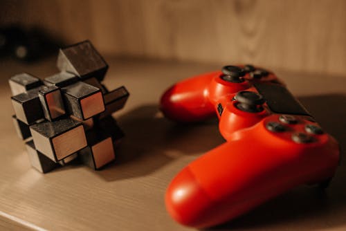 A Cube beside a Red Game Controller