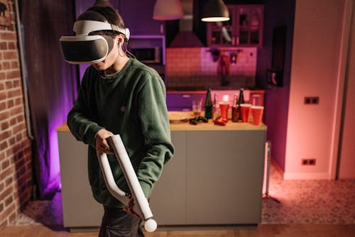 A Person Wearing a VR Headset Carrying an Aim Controller
