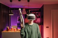 Person Wearing A Virtual Reality Headset With An Aim Controller