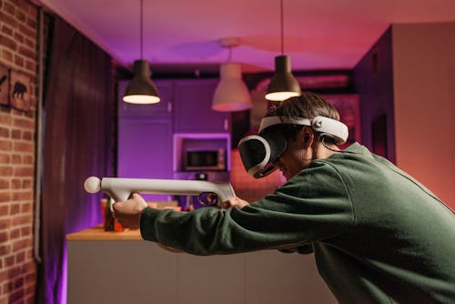 Free A Person Playing a Video Game using an Aim Controller Stock Photo